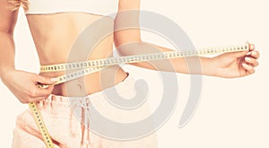 Woman with measuring tape. Weight loss concept. Woman take waist scale tape show her thin waist. Slim girl with