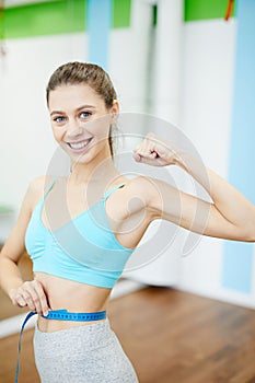 Woman Measuring Waist in Gym