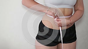 Woman measuring waist measuring tape