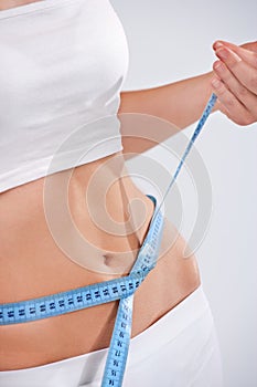 Woman measuring waist of perfect body