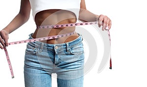 Woman is measuring waist after weight loss.