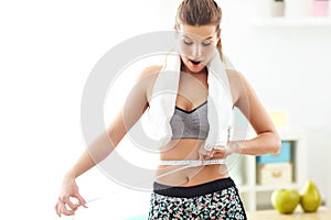 Woman measuring waist after workout