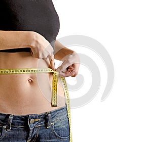 Woman measuring waistline with a tape