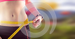 Woman measuring weight with measuring tape on waist on Summer beach