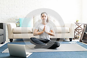 Woman mediating while watching videos online