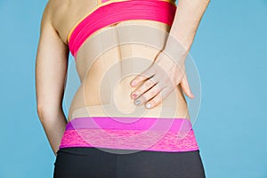 Woman with medical kinesio taping on back