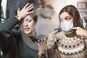 Woman in a medical mask argues and fights with her opponent, who does not believe in the coronavirus and the covid-19