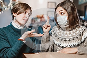 Woman in a medical mask argues and fights with her opponent, who does not believe in the coronavirus and the covid-19