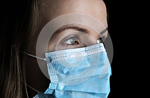 Woman in medical mask on black background. Time of quarantine. Coronavirus pandemia. Virus danger infection. Cold or flu illnesses