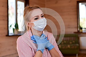 Woman in medical mask is coughing at home. Medical person with fits of suffocating cough.