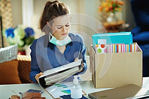 Woman with medical mask organising home office