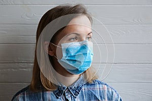 Woman in medical mask on white background. Time of quarantine. Coronavirus pandemia. Virus danger infection. Cold or flu illnesses