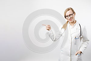 Woman in medical uniform pointing with finger to empty space