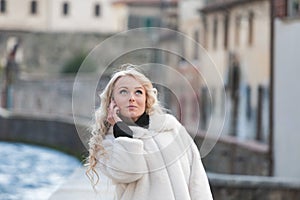 woman in Medieval European city, using phone