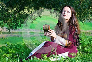 Woman in medieval suit with old casket