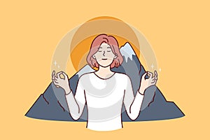 Woman meditates in lotus position and practices zen breathing standing near mountains and sunset