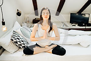 Woman meditating in bed at home.Antistress practice.Overcoming anxiety and fear.Mindfullness meditation morning.Breathing exercise