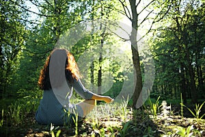 Woman meditating in forest
