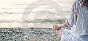 Woman meditating at the Garda Lake. Sunset.