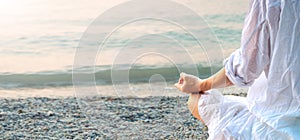 Woman meditating at the Garda Lake. Sunset.