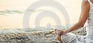 Woman meditating at the Garda Lake. Sunset.