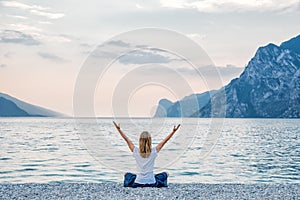 Woman meditating at the lake