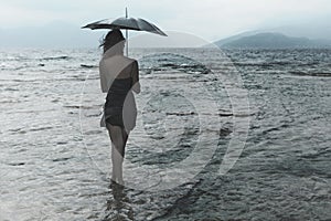 woman meditating looking at infinity in the rain and thunderstorm