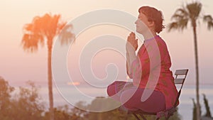 Woman meditating in lotus pose at sunrise. Healthy lifestyle. Morning meditation.Yoga meditation concept. Young woman