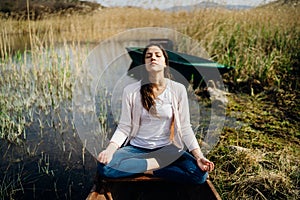 Woman meditating in nature.Escape from stressful reality.Mindful woman practicing meditation.Breathing technique.Mental state