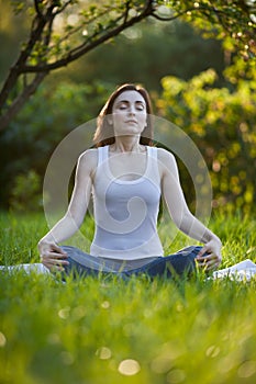 Woman meditating at the park