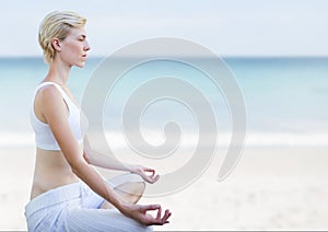 Woman Meditating peaceful on beach