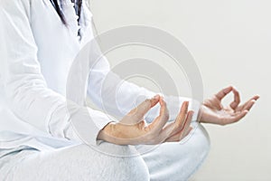 Woman meditating of purity energy insight on gray background, soft focus