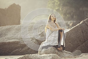 Woman meditating on the sea beach