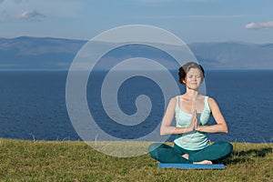 Woman meditating at seaside