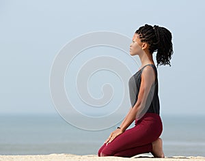 Woman meditating at the seaside