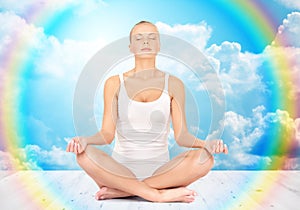 Woman meditating in yoga lotus pose