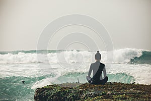 Woman meditation at the seaside cliff edge