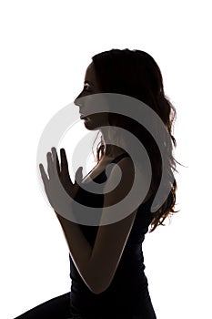 Woman in meditation, silhouette