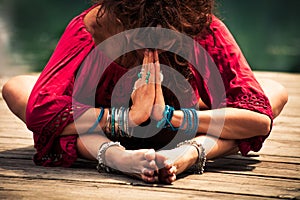 Woman in a meditative yoga position closeup photo