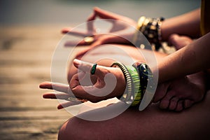 Woman in a meditative yoga position lower body outdoor