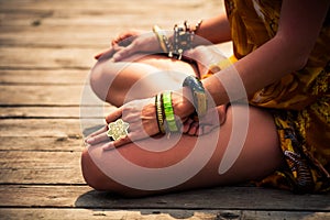 Woman in a meditative yoga position outdoor lower body photo