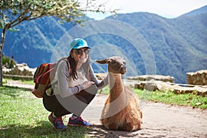 Woman meet lama in hiking trail