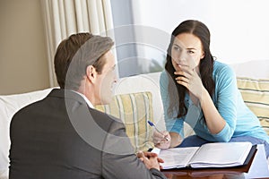 Woman Meeting With Financial Advisor At Home