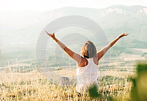 Woman meets sunrise in mountain