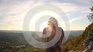 A woman meets the sunset in a beautiful place