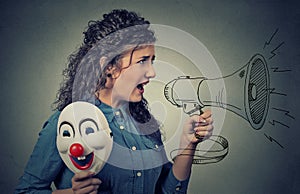 Woman with megaphone and clown mask