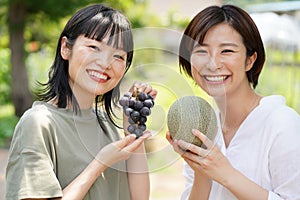 Woman with melon and grapes