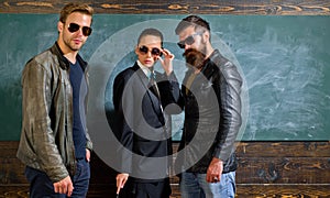 Woman and men wear masculine clothes and eyeglasses. Girl formal jacket suit and guys sunglasses copy space. Fashion