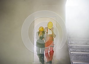 Woman and man workers suffocating at the construction site.