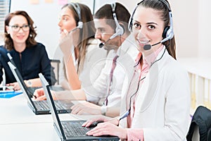 Woman and men working as call center agents